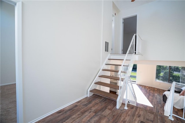 stairs featuring hardwood / wood-style floors