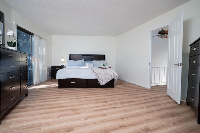 bedroom with a textured ceiling and light hardwood / wood-style flooring