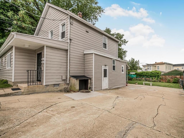 view of side of home with a patio area