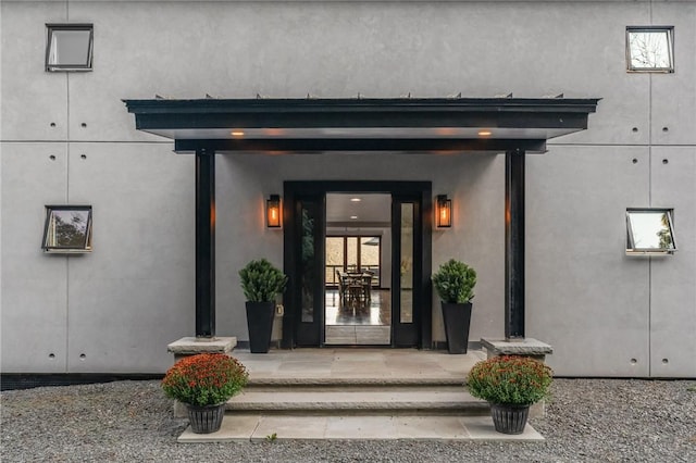 view of exterior entry featuring covered porch