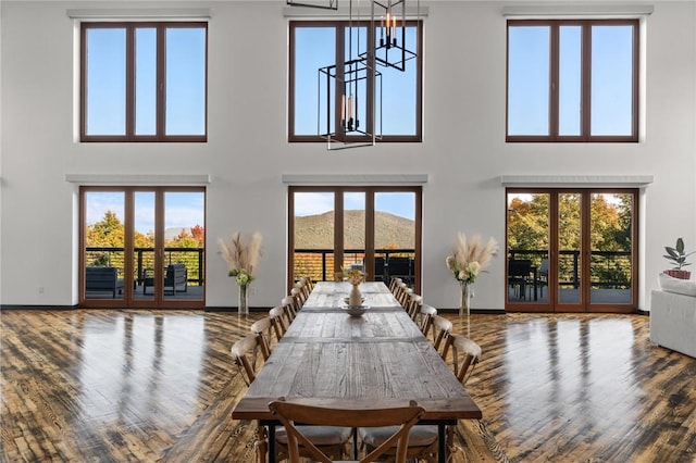 dining space featuring a healthy amount of sunlight and a high ceiling