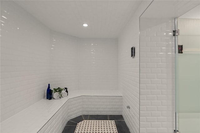 bathroom with tile patterned flooring and walk in shower