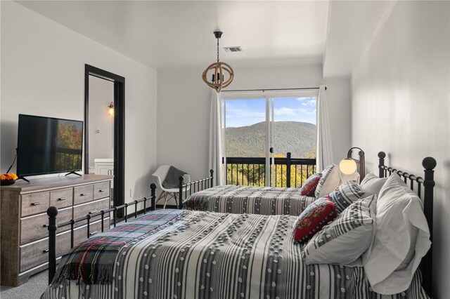 carpeted bedroom featuring a mountain view