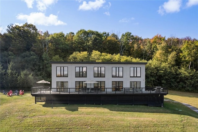 rear view of property with a yard and a wooden deck