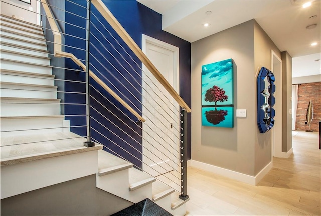 stairway with hardwood / wood-style floors