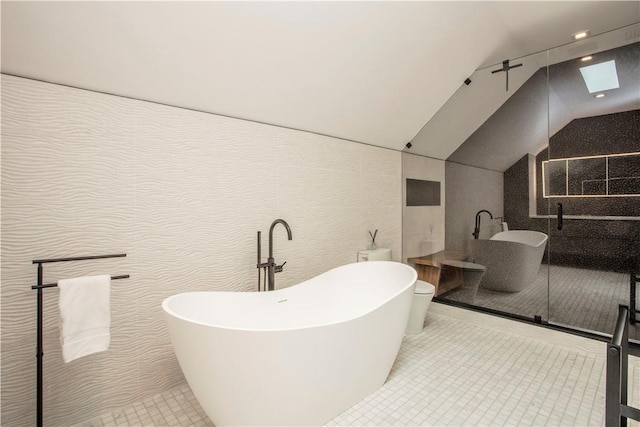 bathroom featuring lofted ceiling with skylight, independent shower and bath, and toilet