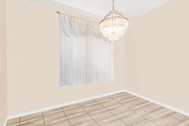 unfurnished dining area with an inviting chandelier