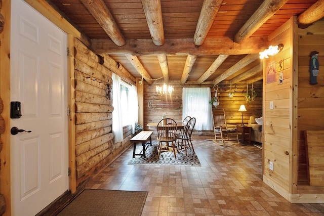 unfurnished dining area with beamed ceiling, wood ceiling, wooden walls, and a chandelier