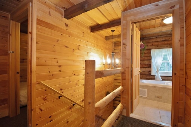 hall with tile patterned floors, beamed ceiling, and wood ceiling