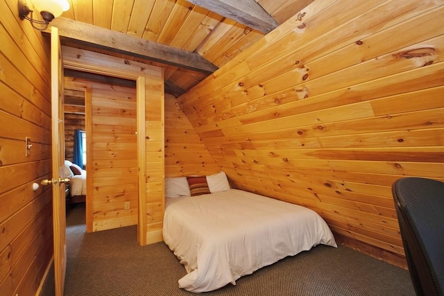 bedroom featuring lofted ceiling with beams, wood walls, wood ceiling, and dark colored carpet