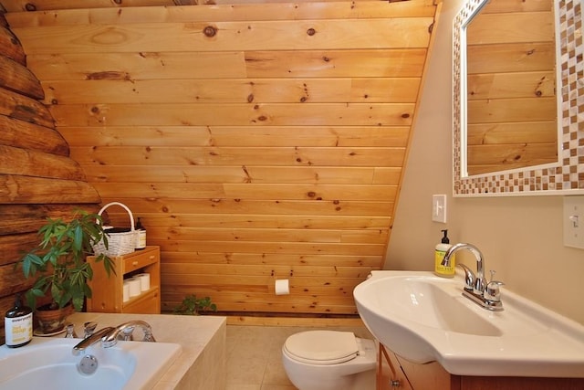 bathroom with a tub, wood walls, vanity, and toilet