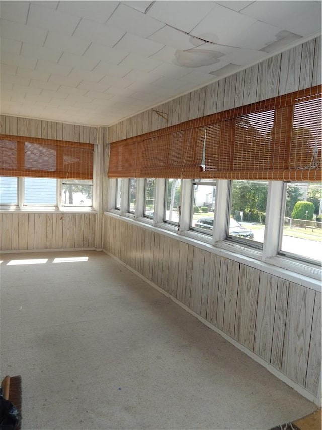 hallway featuring wooden walls