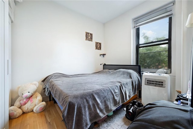 bedroom with hardwood / wood-style flooring