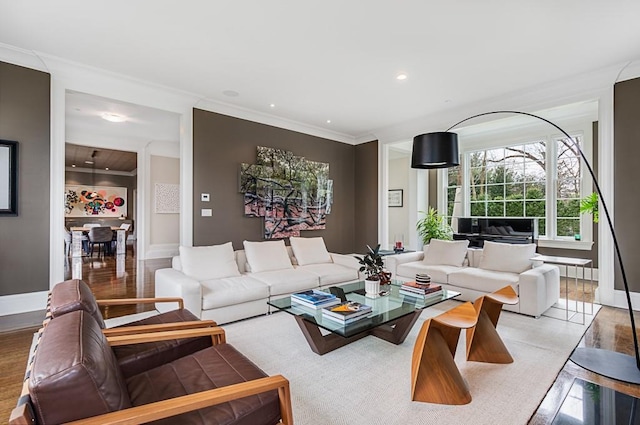 living room featuring ornamental molding and light hardwood / wood-style floors