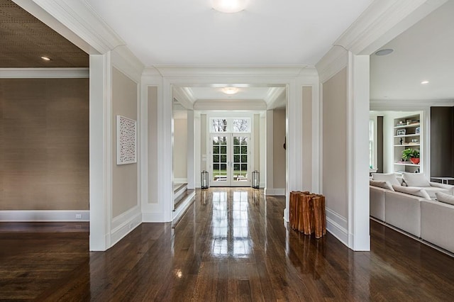 hallway with dark hardwood / wood-style flooring, ornamental molding, and built in features