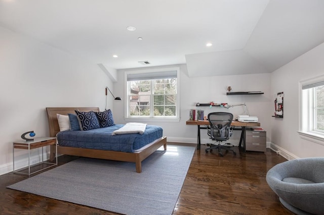 bedroom with vaulted ceiling and dark hardwood / wood-style flooring