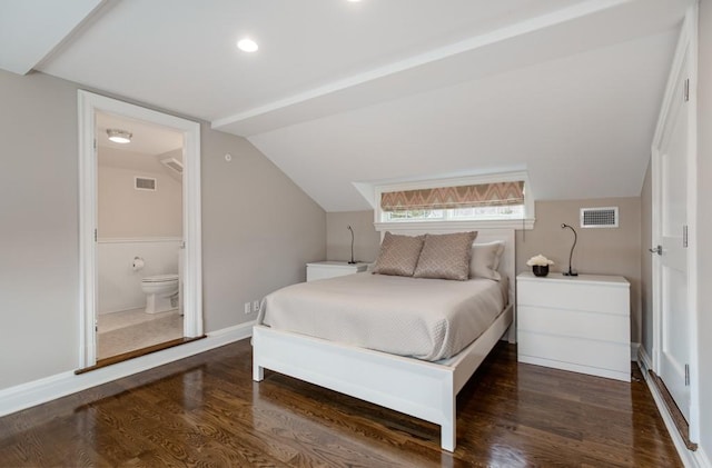 bedroom featuring vaulted ceiling, ensuite bathroom, and dark hardwood / wood-style flooring