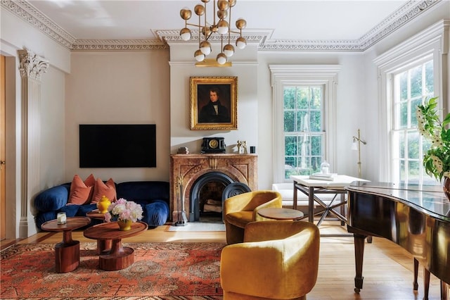 sitting room featuring light hardwood / wood-style flooring, plenty of natural light, and ornamental molding