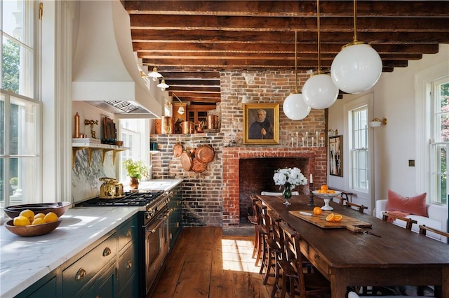 kitchen with dark hardwood / wood-style floors, beam ceiling, high end stainless steel range oven, and brick wall