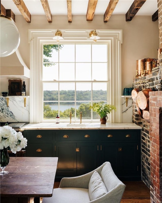 interior space featuring beamed ceiling, dark hardwood / wood-style floors, and a water view