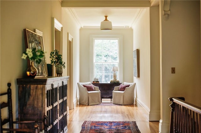 living area featuring light hardwood / wood-style flooring and crown molding