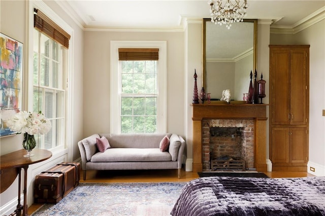 living area with a fireplace, light hardwood / wood-style floors, a wealth of natural light, and crown molding