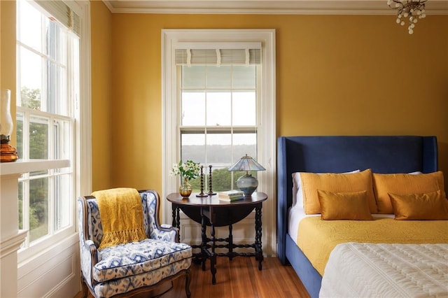 bedroom with hardwood / wood-style floors and ornamental molding