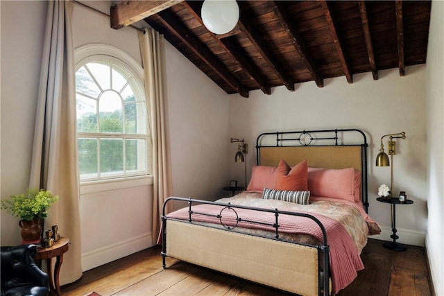 bedroom featuring wood ceiling, vaulted ceiling with beams, and light hardwood / wood-style floors