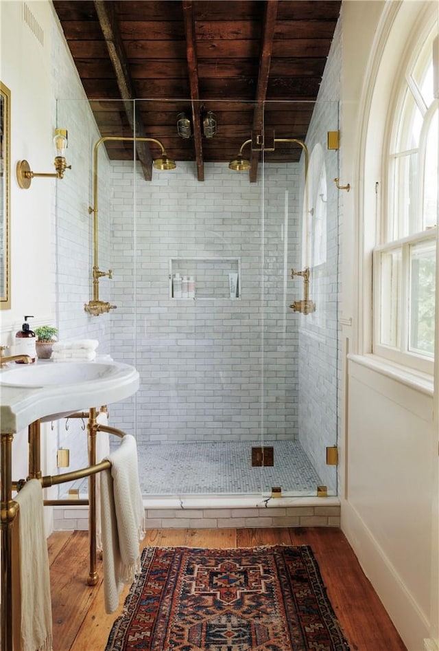 bathroom with wood ceiling, wood-type flooring, beam ceiling, and walk in shower