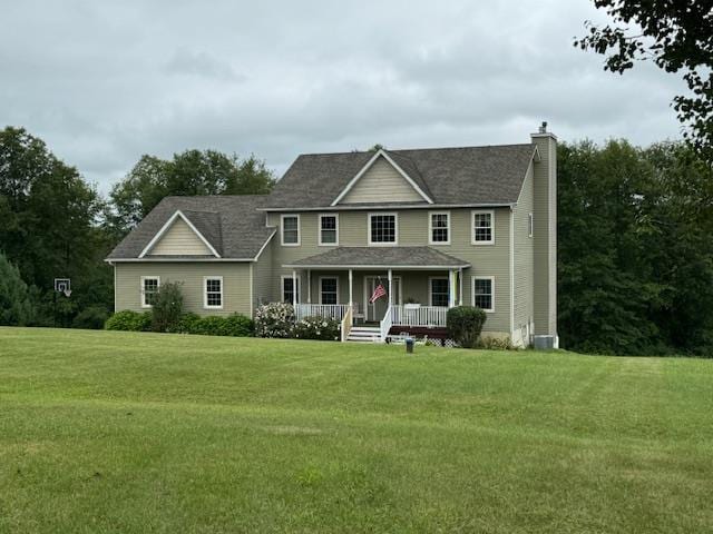 colonial home with covered porch and a front lawn