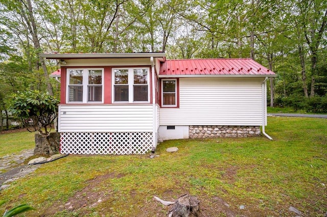 view of home's exterior featuring a lawn