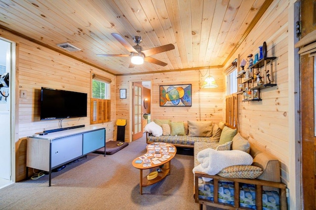 living room with carpet, ceiling fan, wooden walls, and wood ceiling