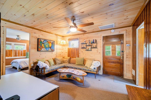 living room featuring carpet, wooden walls, ceiling fan, and wooden ceiling