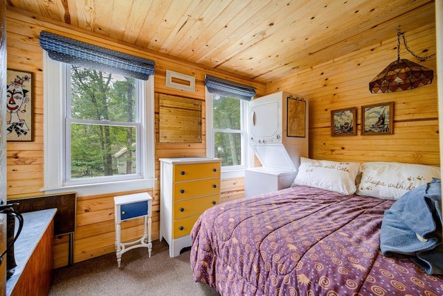 bedroom featuring carpet floors, wood ceiling, multiple windows, and wood walls