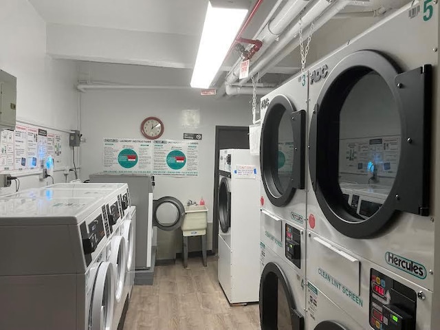 washroom featuring stacked washer / dryer, washer and dryer, and light wood-type flooring