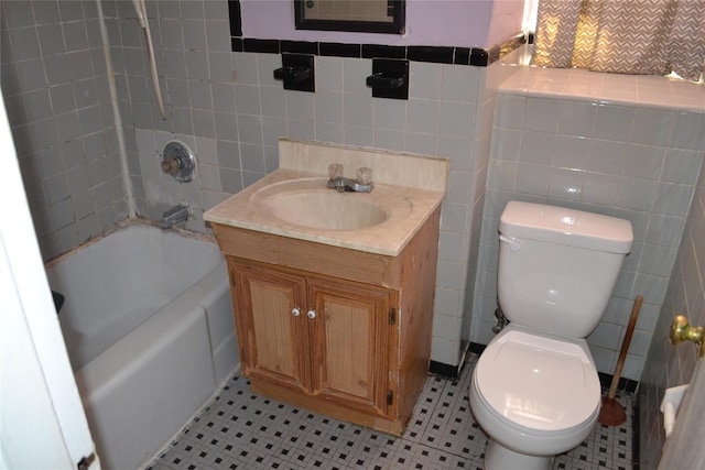 bathroom featuring tile patterned flooring, vanity, toilet, and tile walls