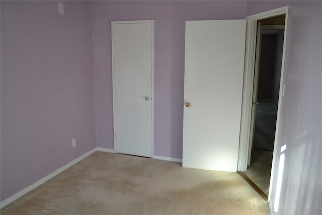 unfurnished bedroom with light carpet