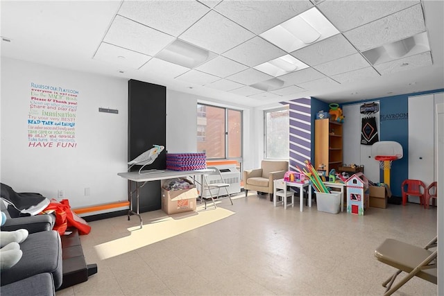 recreation room featuring a drop ceiling