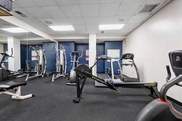 gym featuring a paneled ceiling