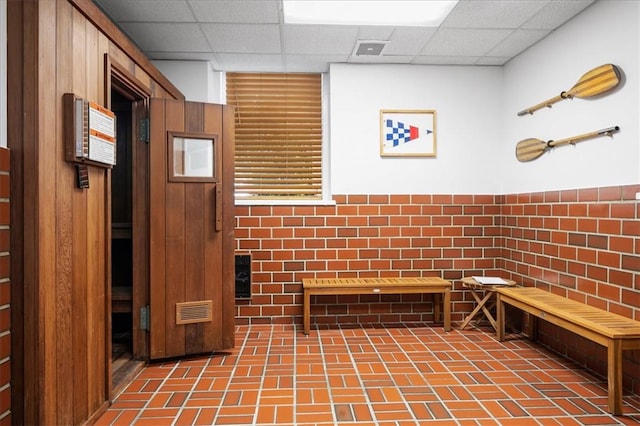 interior space with a paneled ceiling