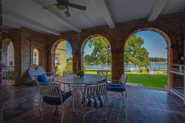 view of patio featuring ceiling fan and a water view