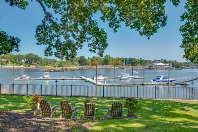 view of yard with a boat dock and a water view