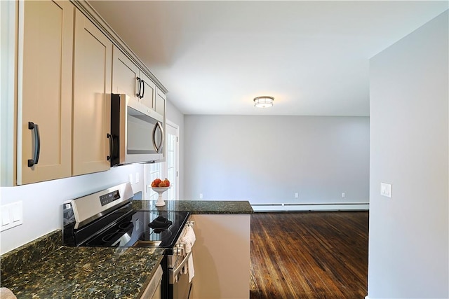 kitchen featuring stainless steel appliances, dark hardwood / wood-style floors, a baseboard heating unit, and dark stone countertops