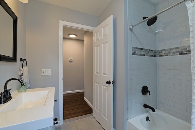 bathroom featuring vanity, wood-type flooring, and shower / tub combo