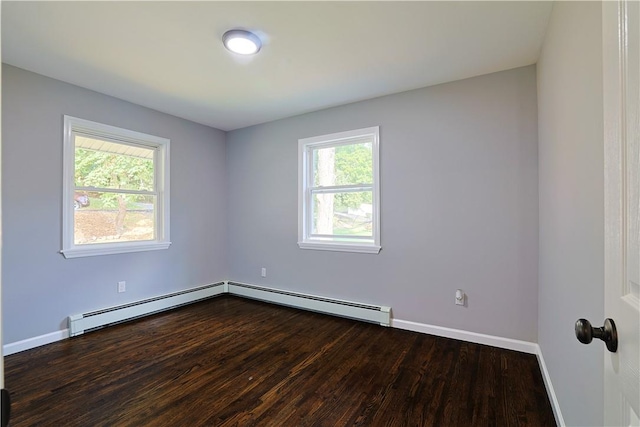 unfurnished room with baseboard heating and dark wood-type flooring