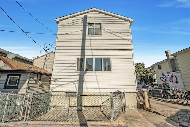 view of property exterior with fence private yard and a gate