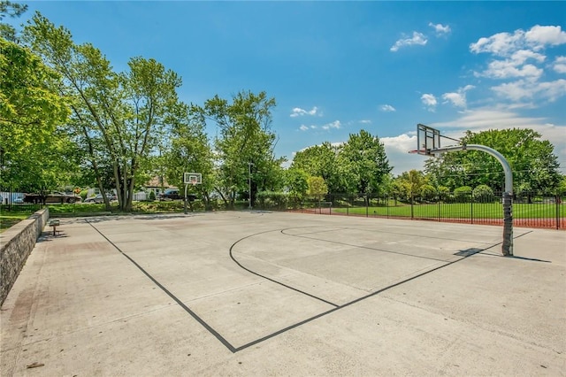 view of basketball court with community basketball court and fence