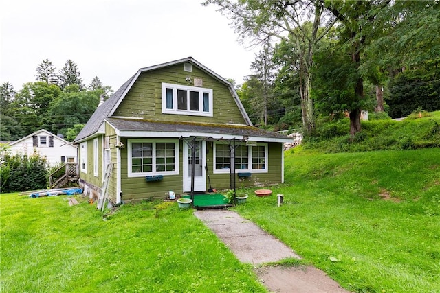 bungalow-style home with a front yard