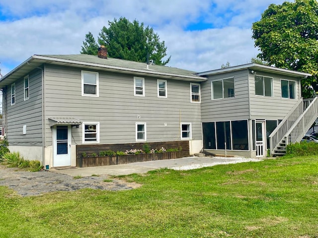 rear view of property with a yard