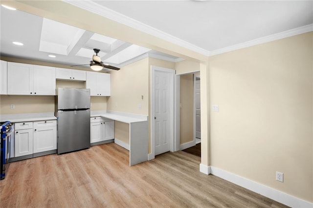 kitchen featuring white cabinets, stainless steel appliances, light hardwood / wood-style flooring, and beamed ceiling